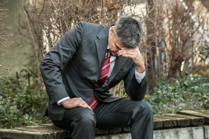 Depressed businessman in the park