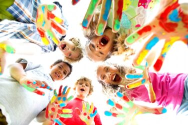Children with brightly painted hands