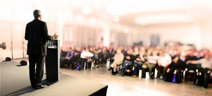 Fear of Public Speaking banner - man making presentation to a large crowd