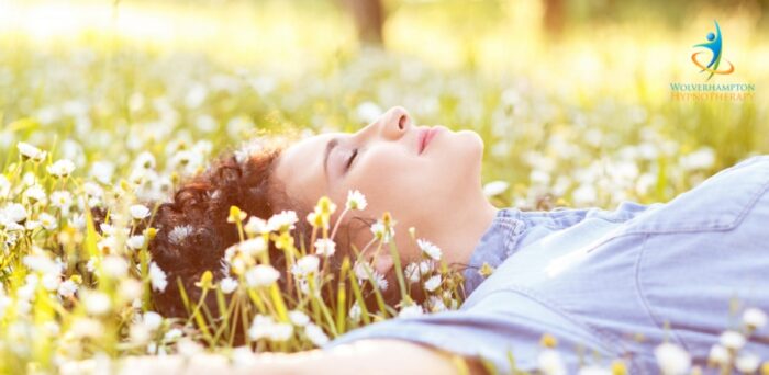 Girl lying in a summer daisy field