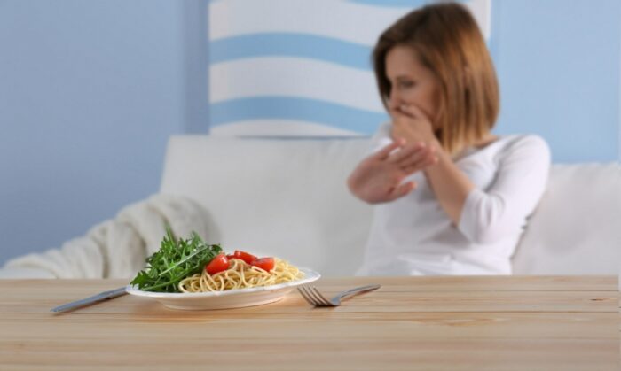 Young woman wih eating problems refusing to eat