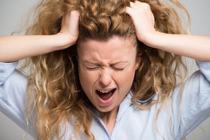 Anxious woman pulling her hair