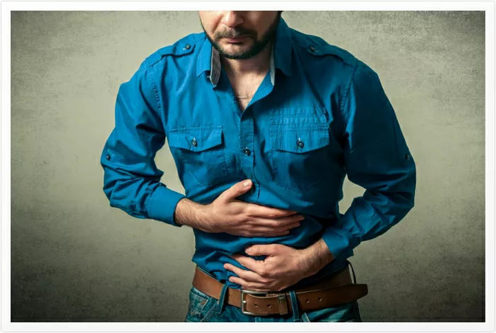 Man in pain holding his stomach