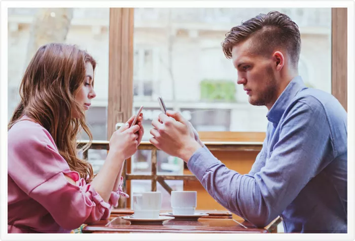 young couple using the internet whist having dinner