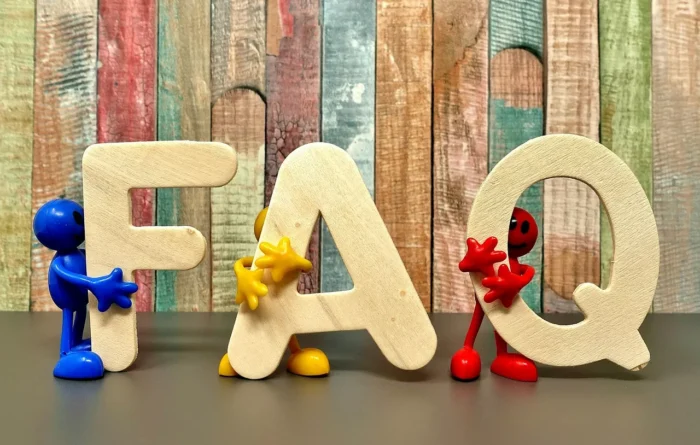 FAQ held by wooden men