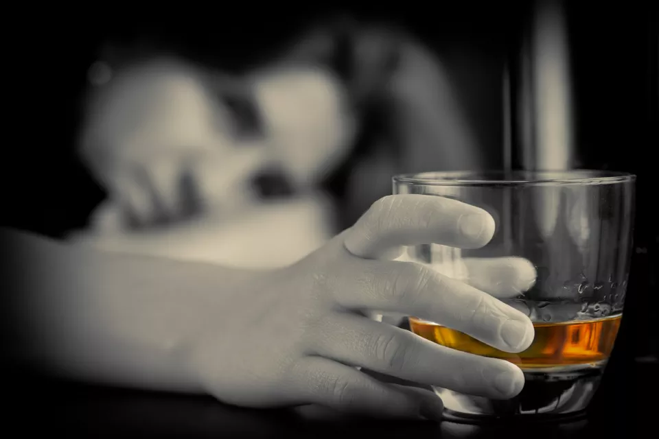 alcohol-addiction-woman-holding-whiskey-glass-960px