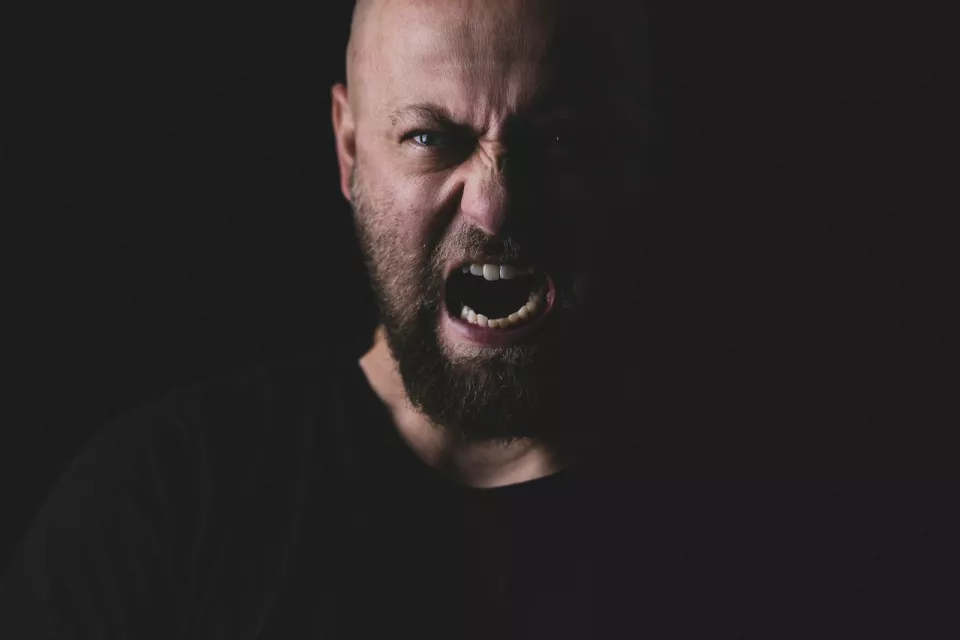 Angry man shouting at the viewer