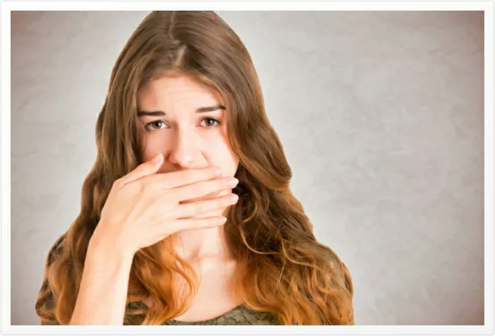 blushing-woman-covering-mouth