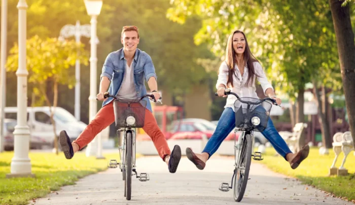 Happy young couple riding their bikes